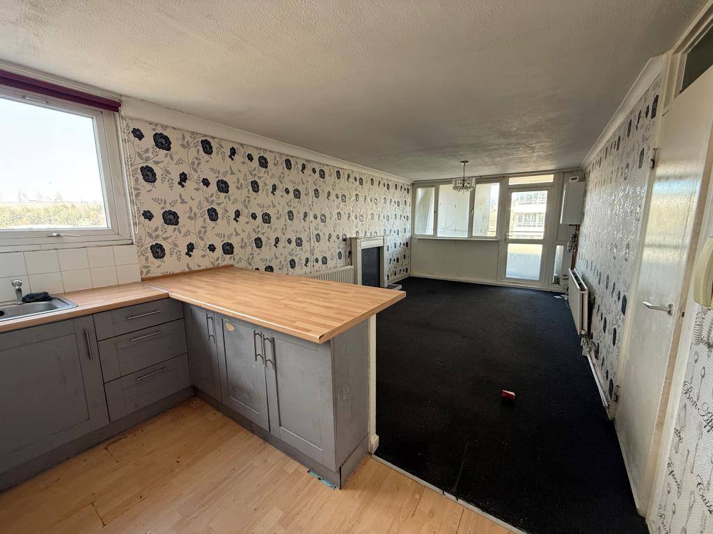 Lot: 137 - TWO-BEDROOM FLAT FOR IMPROVEMENT - Kitchen looking towards living room